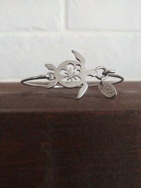 Dainty silver tone turtle and flower cuff bracelet